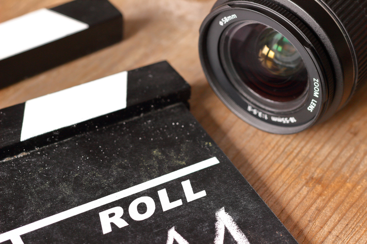 Film Clap Board Film Slate with Camera Lens on Wooden Background