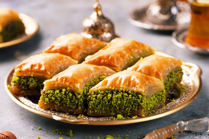 Baklava with pistachios and tea on table. Turkish cuisine