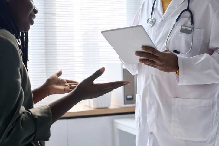 Close Up of Woman Gesturing and Talking to Doctor