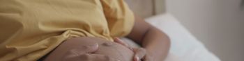 A Mother's Touch, A Close up of a Pregnant Woman's Hands on Her Belly