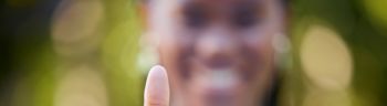 Hand, closeup and thumbs up by black woman showing yes, recommendation or thank you on bokeh background. Zoom, hands and emoji sign, symbol or icon by corporate employee in agreement, support or vote