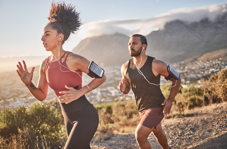gospel workout music - Fitness, exercise and black couple running for cardio health on mountain road for speed, energy and wellness. Man and woman runner listen to music outdoor for workout and training for marathon race