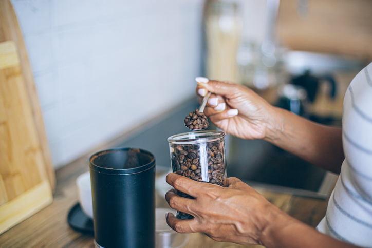 coffee around the world - Grinding coffee beans in a coffee grinder