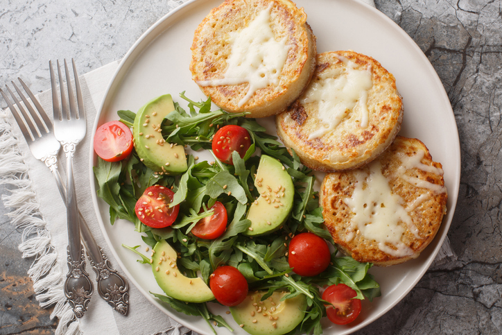 healthy meals type 2 diabetes - Fried crumpets in beaten egg with fresh vegetable salad for breakfast close-up in plate. Horizontal top view